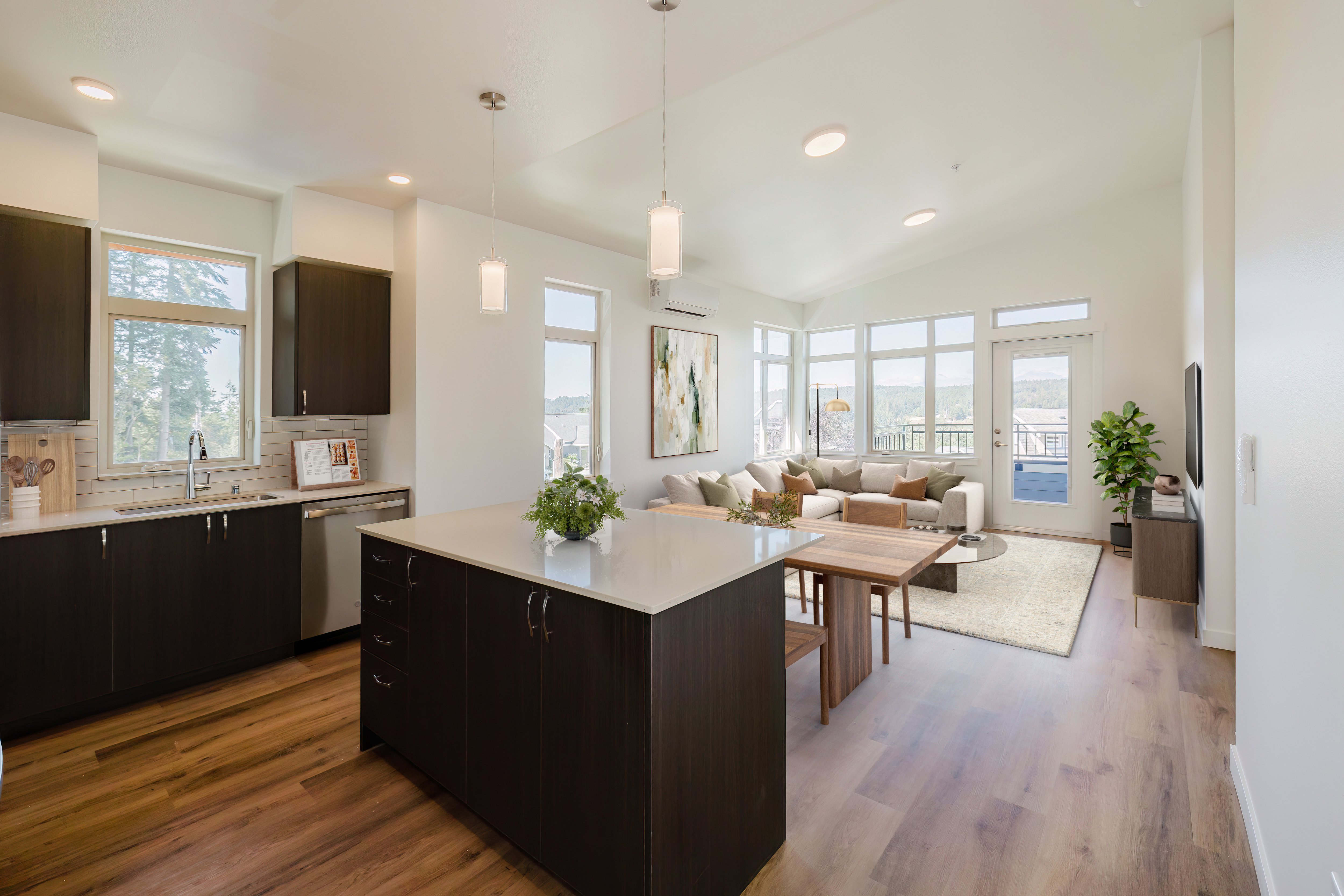 A modern kitchen with dark brown cabinets and a wooden island.